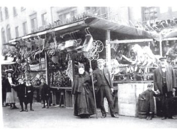 Exchange Corner 1908 at Goose Fair. It is probably Charles Beecroft holding the hand of grandson John Hooton Beecroft aged 4 1/2 years CHARLES BEECROFT ON HIS STALL OUTSIDE EXCHANGE CORNER SHOP